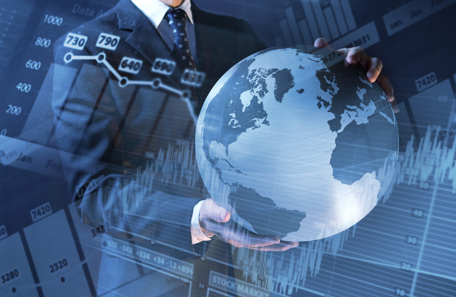 Global economy: manager holds world globe, charts, finance data